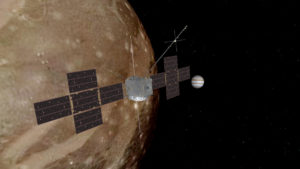 La sonda Juice in prossimità del satellite di Giove Ganimede, con il pianeta sullo sfondo