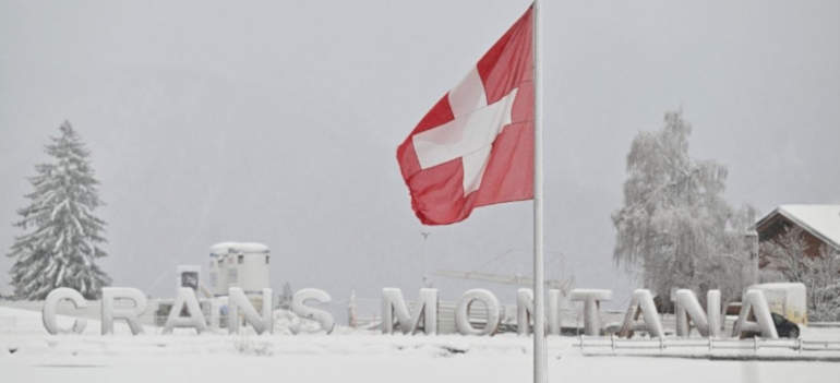 La scritta CRANS-MONTANA sullo sfondo della bandiera svizzera