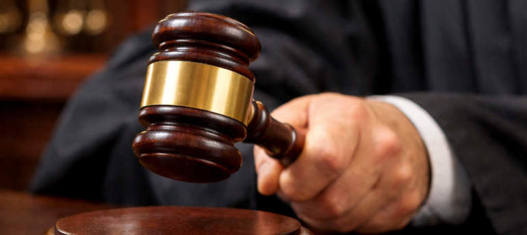 Giudice che batte con il martello sul tavolo